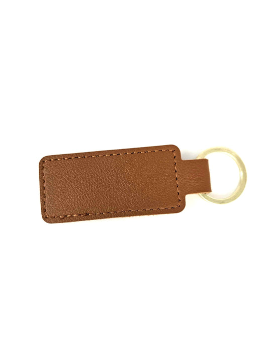 Brown leather keychain with a gold ring on a white background